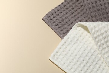Clean waffle towels on beige background, top view. Space for text