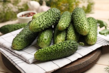 Making pickles. Fresh cucumbers on light wooden table, closeup
