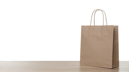 One kraft paper bag on wooden table against white background