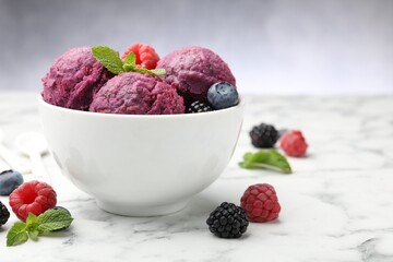 Delicious sorbet with fresh berries and mint in bowl on white marble table against grey background, closeup