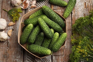 Making pickles. Fresh cucumbers and spices on wooden table, flat lay