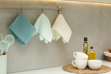 Clean waffle towels hanging on hook rack in kitchen