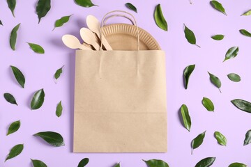 Different eco friendly packaging and leaves on violet background, flat lay