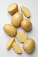 Fresh raw potatoes on light grey background, flat lay