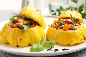 Tasty stuffed pattypan squashes on grey table, closeup