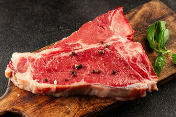 Raw steak T-bone fresh meat premium beef snack fresh delicious gourmet food background on the table rustic food top view copy space