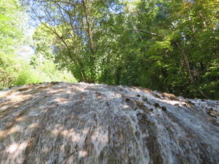 beautiful waterfall forming a river of reflections, soothing sound