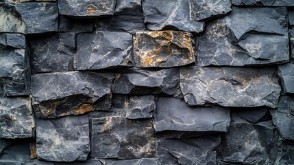 close up texture of rough black stones with cracks and patches