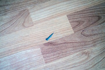 Large scratch damage on wood-look laminate flooring, showing wear and tear on modern interior...