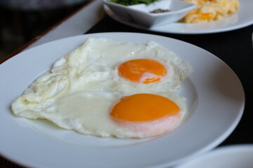 two heart shaped eggs on a plate Asian food, sunny side up fried egg on rice for breakfast image. High quality photo