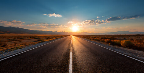Empty long mountain road to the horizon on a sunny summer day at bright sunset