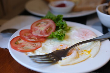 Healthy food, breakfast meal consist of egg, tomato, lettuce, on white plate on a marble table. High quality photo