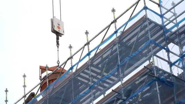 FRANKFURT, GERMANY - AUGUST 14: Crane moving equipment around construction site in Roemer downtown of Frankfurt, Germany on August 14, 2014.