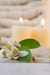Close-up of orange blossoms on a table with candles and towels, spa atmosphere