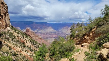 Scenic Trail View of Grand Canyon Under Dramatic Cloudy Sky