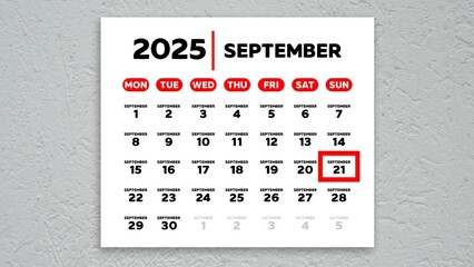 The date September 21st marked with a red cursor on the wall calendar 2025