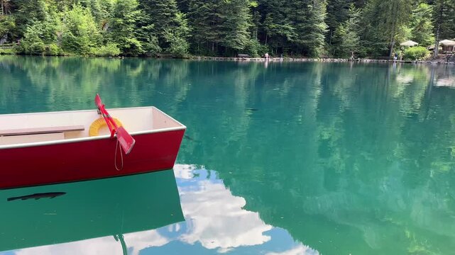 Crystal-clear Blausee lake in Switzerland, where the water is so transparent you can see fish swimming below. Pristine alpine nature, peaceful atmosphere, and stunning natural beauty. Kandergrund 