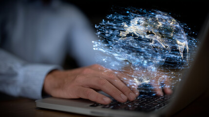 Male hands in motion over a laptop keyboard, a vivid 3D digital globe with orbiting data lines superimposed above, emphasizing worldwide technology and connectivity,