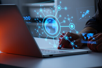 Person using a laptop with a glowing digital globe and network connections, symbolizing global communication, big data, digital networking, and information exchange in cyberspace