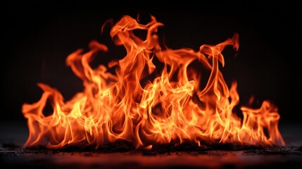 Intense flames of fire burning brightly with a dark background, showcasing heat and energy.