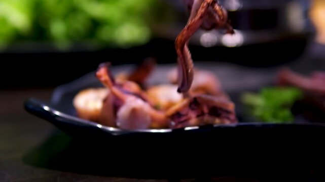 Alien-Shaped Octopus Dances on Food Top view of the traditional asian grill or hot pot in Thail restaurant cooking seafood and meat. High quality 4k footage