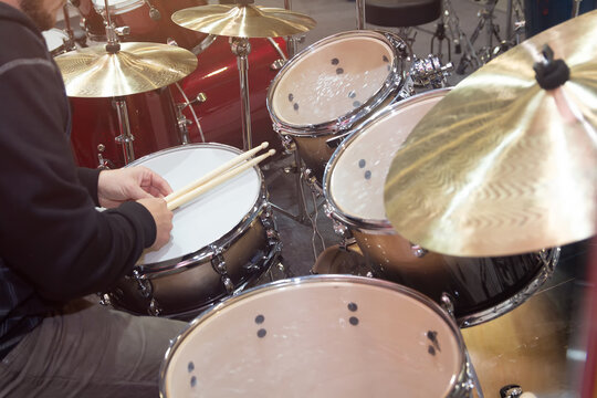 The drummer plays drum installations - Powered by Adobe