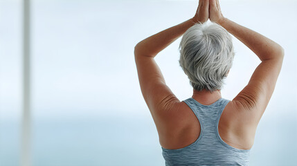 Senior woman with gray hair in prayer position for meditation. Elder lady exercising yoga for wellness and healthy lifestyle.