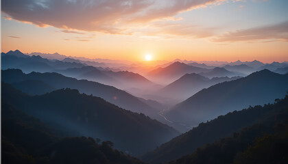 Obraz premium Majestic Sunrise Over Misty Mountain Ranges.
