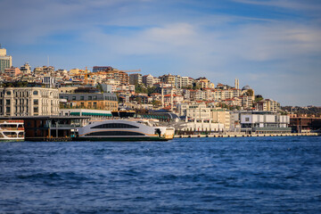 Galata Port waterfront with a ferry and Karakoy neighborhood in Istanbul, Turkey