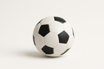 Obraz premium Classic black and white soccer ball on a light surface, ideal for sports, training, and athletic-themed visuals.