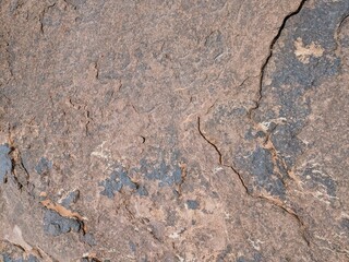 Natural texture of stone surface with cracks and weathering details