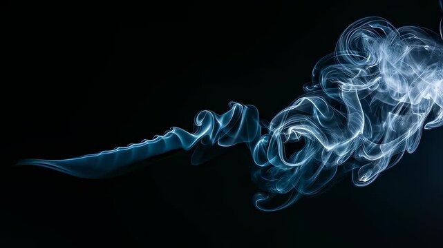 Ethereal blue smoke wisps floating on black background. Artistic vapor flow with swirling patterns. Abstract fluid motion video for visual effects and design projects.
