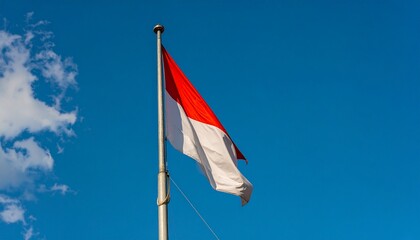 Reaching the Summit. An ultra-realistic photograph showing the red and white flag as it reaches the very top of the flagpole. The composition is a tight shot of the top of the pole