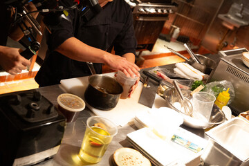 chef prepares food in busy kitchen