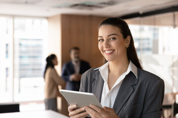 Head shot portrait cheerful friendly millennial businesswoman in formal suit entrepreneur executive...