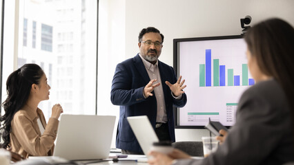 Corporate training. Experienced mid aged business coach trainer lead education event at modern...