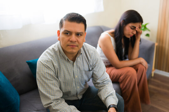 Latin couple having problems and discussing with psychologist during therapy session