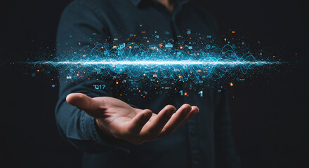 A person holding a glowing stream of digital data and information in their outstretched hand on black