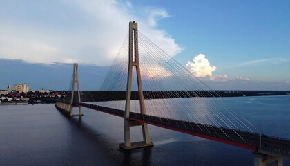 Obraz premium Cable-stayed bridge over a river at sunset