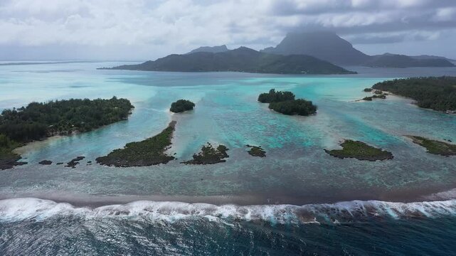 Aerial view of Blue Heaven Island in Bora Bora, French Polynesia, featuring crystal-clear waters