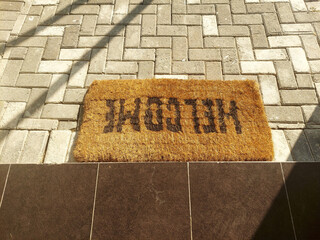 exit sign on the road, Upside Down Welcome Doormat on Outdoor Pavement