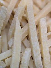 Close-up of frozen french fries, coated in frost, high detail, realistic texture, shallow depth of...
