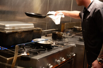 chef prepares food in busy kitchen
