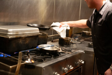 chef prepares food in busy kitchen