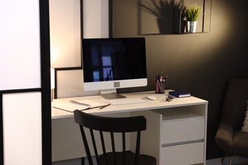 Desk with computer, stationery and glasses at home office. Interior design