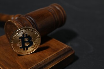 Cryptocurrency. Bitcoin and judge's gavel on black table, closeup. Space for text
