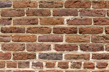 Weathered Brick Wall Texture. Close-up of weathered plantation bricks with visible slave fingerprints, showcasing unique texture and history.
