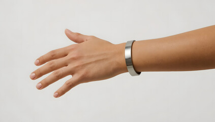 Close-up of a woman's arm showcasing a simple, metallic bracelet.