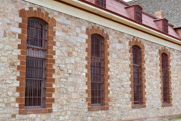 Long barred windows on old prison.