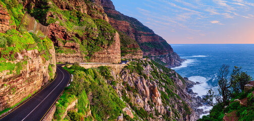 Fototapeta premium Panorama of Chapman’s Peak Drive and the Atlantic Ocean at sunset, Cape Town, South Africa